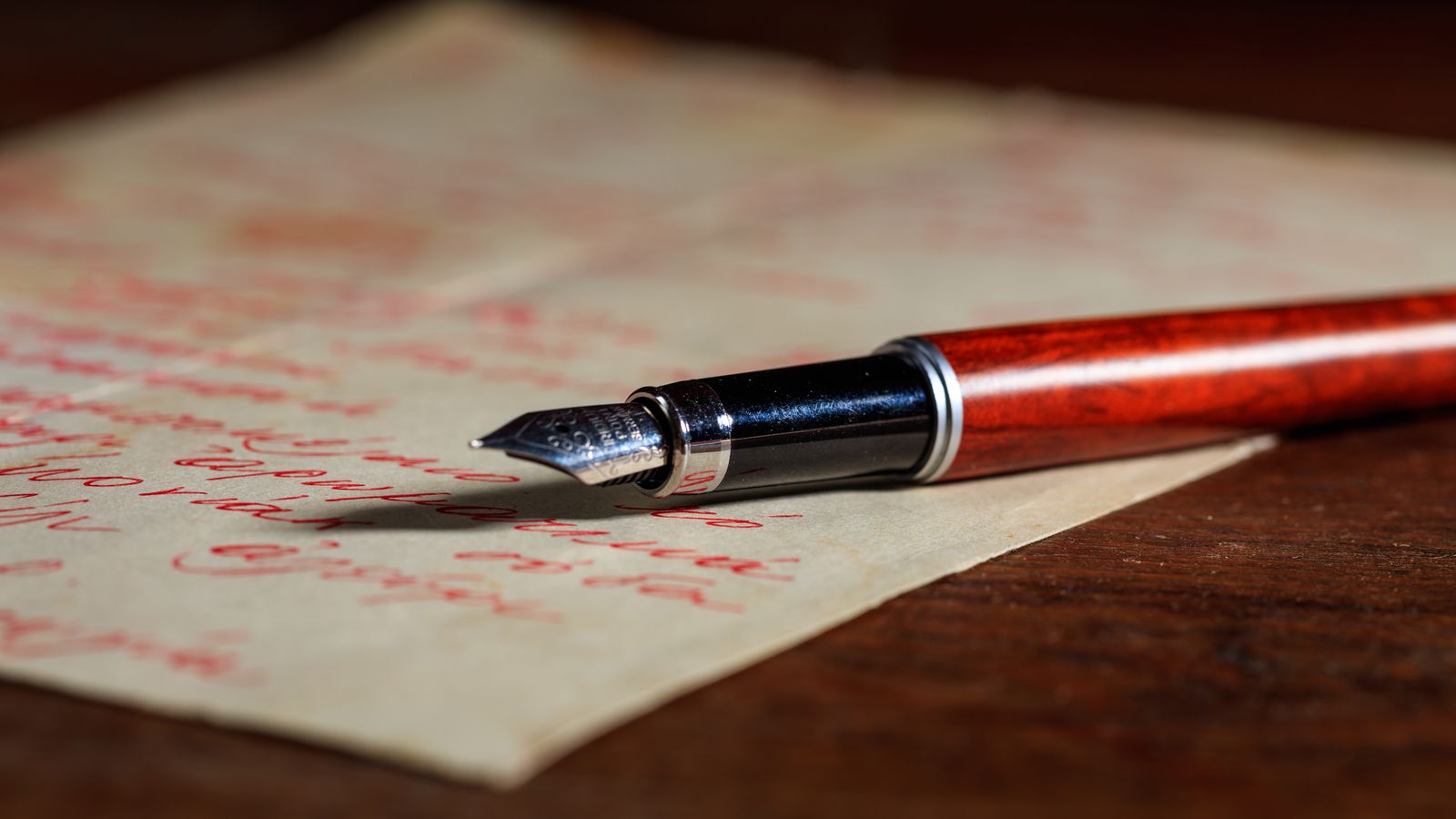 Hand writing notes on lined paper with a pen